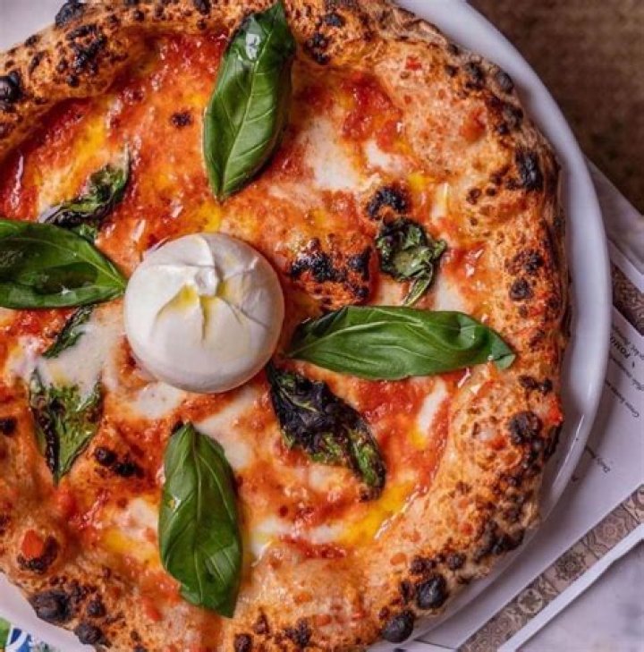 What a pizzeria cooks pizza in